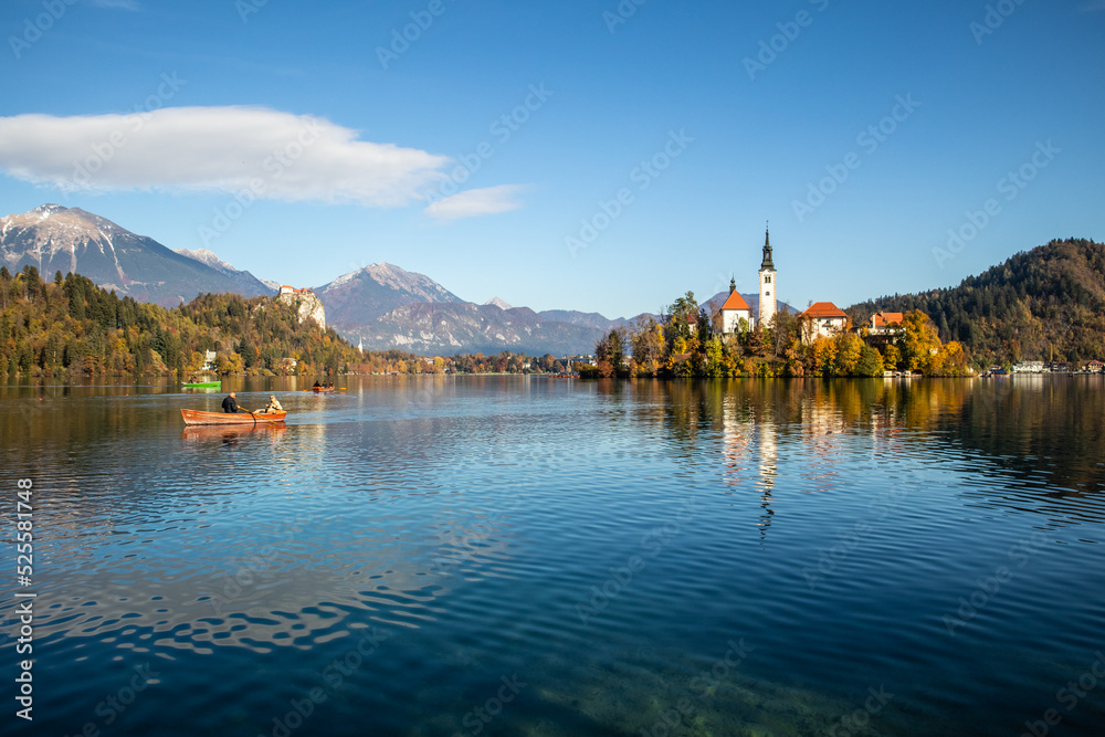 Panoramic view of Julian Alps, Lake Bled with St. Marys Church of the Assumption on the small island. Bled, Slovenia, Europe.