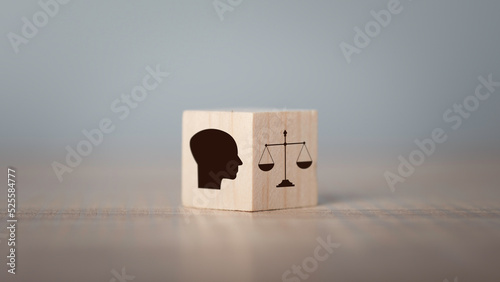 Ethics inside human mind, Business ethics concept. Hand flip ethics inside a head symbols in wooden cubes on dark background with copy space.. photo