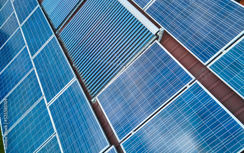 Photovoltaic panels and vacuum air solar collectors for water heating and producing of clean electricity mounted on house rooftop. Production of renewable electric and heat energy with zero emission