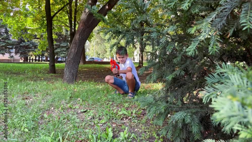 A boy playing with his nerf gun at the park. A boy playing with his nerf gun at the park.