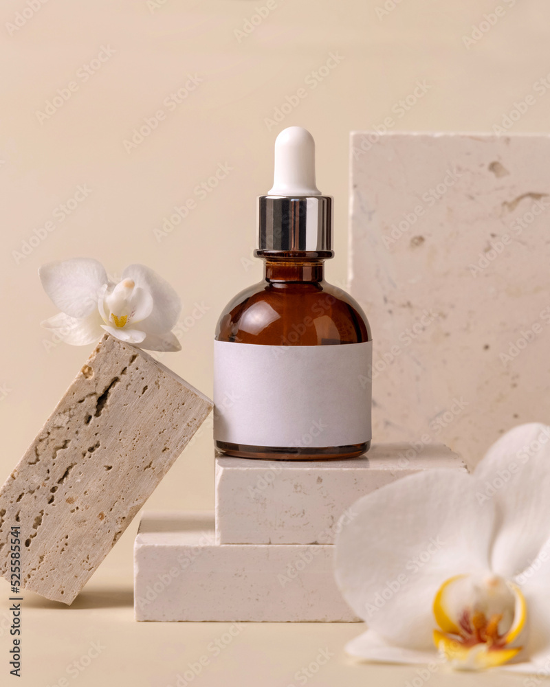 Glass Dropper bottle on stone near white orchid flowers on light yellow close up, Cosmetic Mockup