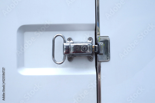 Closed white refrigerated truck door lock close
