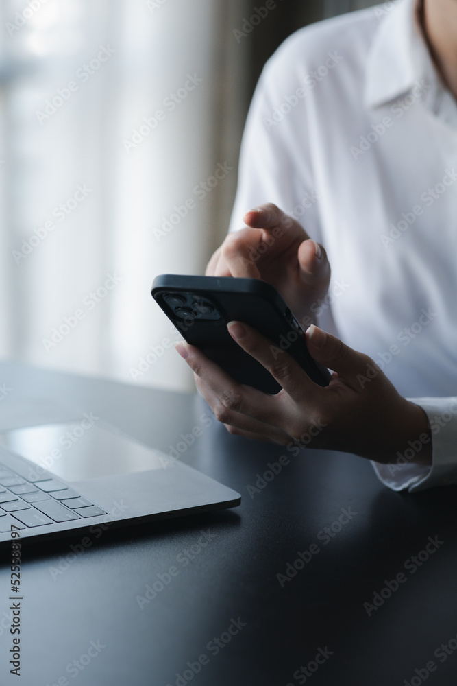 A person is using a smartphone to chat with friends through an application, telecommunication via the Internet on a mobile phone. Concept of using technology in communication. A person is using a smartphone to chat with friends through an application, telecommunication via the Internet on a mobile phone. Concept of using technology in communication.
