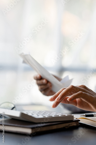 People are pressing calculators and carrying bills and bills to systematically allocate income and expenses, financial planning to keep finances in order. Personal finance management concept.