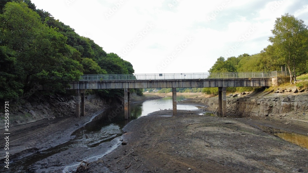 Bridge over a reservoir with low water levels due to the hot dry weather in England. Taken in Bolton Lancashire. Bridge over a reservoir with low water levels due to the hot dry weather in England. Taken in Bolton Lancashire.