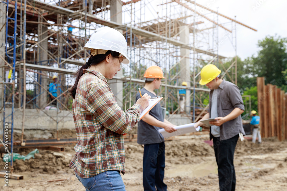 Construction concept of Engineer and Architect working at Construction Site with blue print