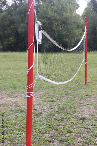 Net on the volleyball court in the park, grass on the sports ground, Moscow region, Serpukhov, August 2022. photo