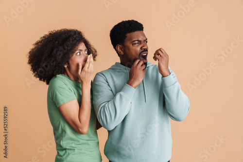 Black man and woman expressing fear and outrage while looking aside