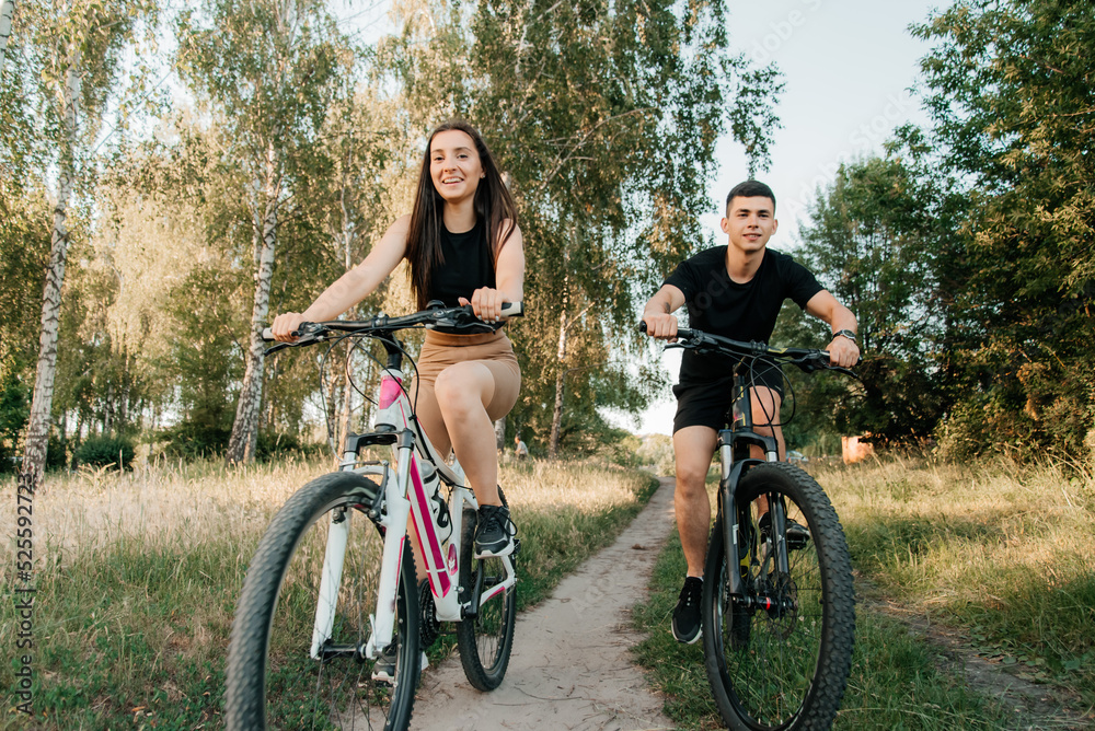 Happy young couple on a bike ride in the countryside Happy young couple on a bike ride in the countryside