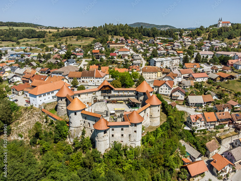 Aerial drone view of Medieval castle of Zuzemberk or Seisenburg or Sosenberch, positioned on terrace above the Krka River Canyon, Central Slovenia.