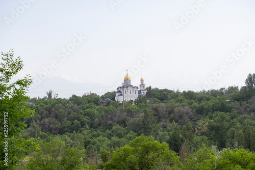 Russian Orthodox Church in the middle of the forest. The golden domes of the church rise above the forest. © Сергей Дудиков