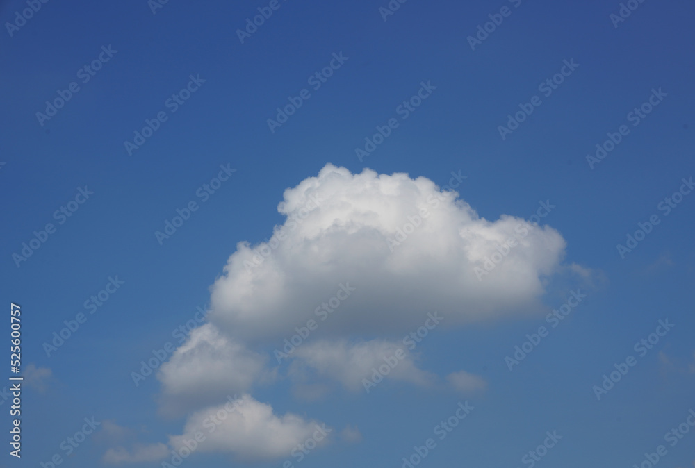 single cloud floats on blue sky background single cloud floats on blue sky background