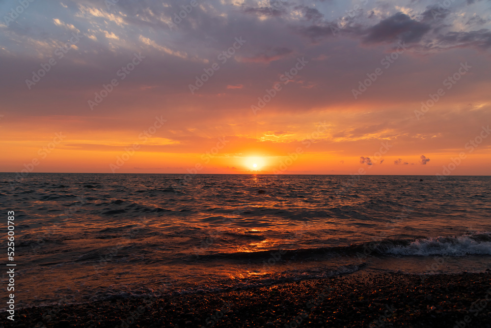 Sea landscape. Beautiful sunset over the sea with bright orange clouds.
