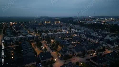 Aerial footage of a cityscape with lighted streets and buildings at the eveningn photo