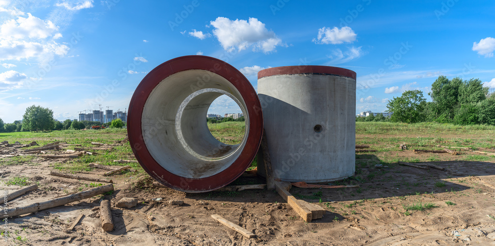 Reinforced concrete storm sewer pipes of large diameter stacked at a construction site. Sewer Large diameter pipes. Reinforced concrete storm sewer pipes of large diameter stacked at a construction site. Sewer Large diameter pipes.