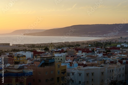 Aerial view of village Tamraght surrounded by buildings and water during sunset photo