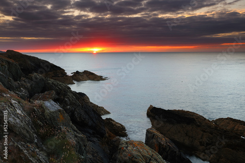 Sun Setting over the sea at Point Lynas, Anglesey, North Wales, UK.