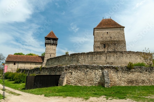 Fortress Calnic during a bright day under a blue sky with clouds, Kelnek, Alba county, Romania photo