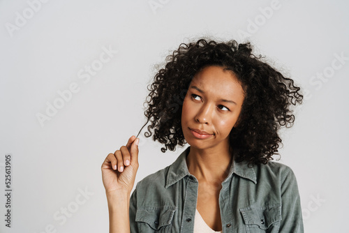Black young woman wearing shirt frowning while looking aside
