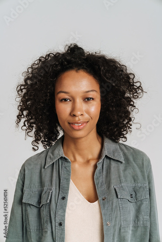 Black young woman wearing shirt smiling and looking at camera