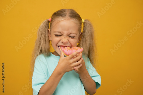 Funny girl with donuts on a yellow background