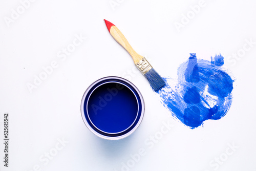 blue paint scribbles and paint cans on a white background
