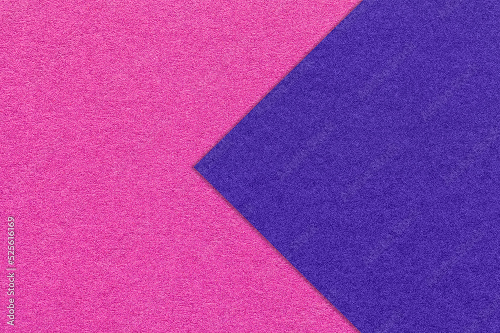 Fototapeta premium Texture of magenta paper background, half two colors with navy blue arrow, macro. Craft purple cardboard.