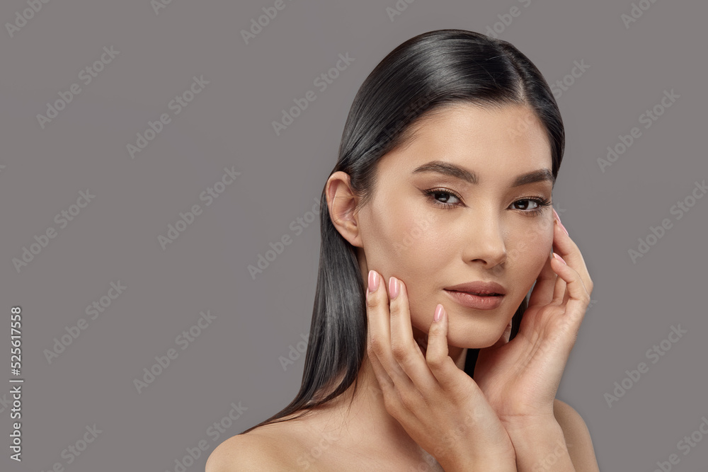Young woman touching clean ideal skin of her face. Young woman touching clean ideal skin of her face.