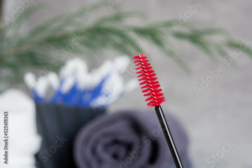 Brush for combing eyelashes, red brush for eyebrows, gray towel, cotton buds, browist, leishmaker, cosmetics for brow and eyelashes, beauty treatments photo