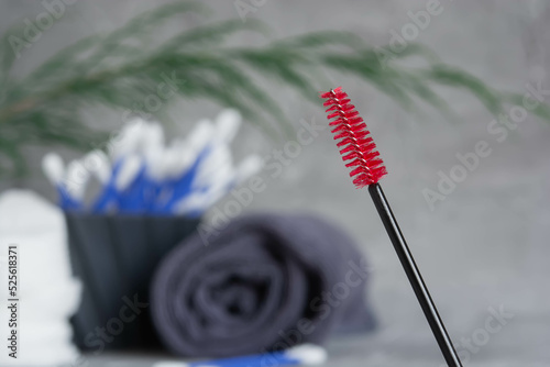 Brush for combing eyelashes, red brush for eyebrows, gray towel, cotton buds, browist, leishmaker, cosmetics for brow and eyelashes, beauty treatments photo