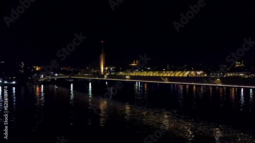 Drone shot of Istanbul's Golden Horn metro bridge at night with the river photo