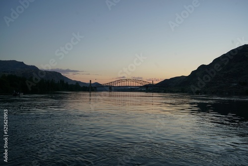 Beebe bridge on Columbia River in Washington before sunrise with blue sky and silhouettes of hills photo