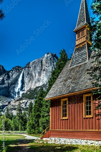 Beautiful house against a rocky mountain in the countryside photo