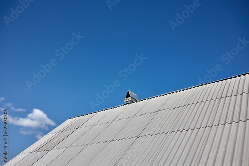 new asbestos roof on the house, blue sky view