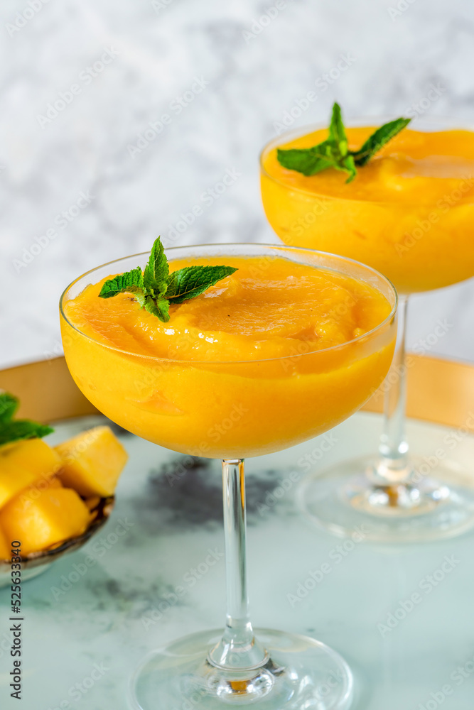 Frozen mango daiquiri with white rum garnished with fresh mint Frozen mango daiquiri with white rum garnished with fresh mint
