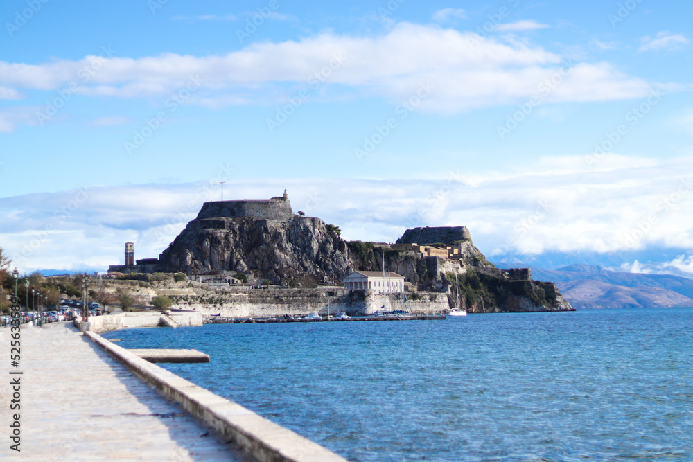 The Old Venetian fortress of Corfu town, Greece. Paleo Frourio with walls going to sea and clock tower in the morning, located at Kerkyra city.