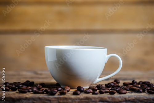 A cup of coffee with coffee bean on wooden background