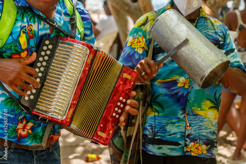 Dominican Republic. Beach musicians. Merengue music. Playing the accordion and guiro. photo