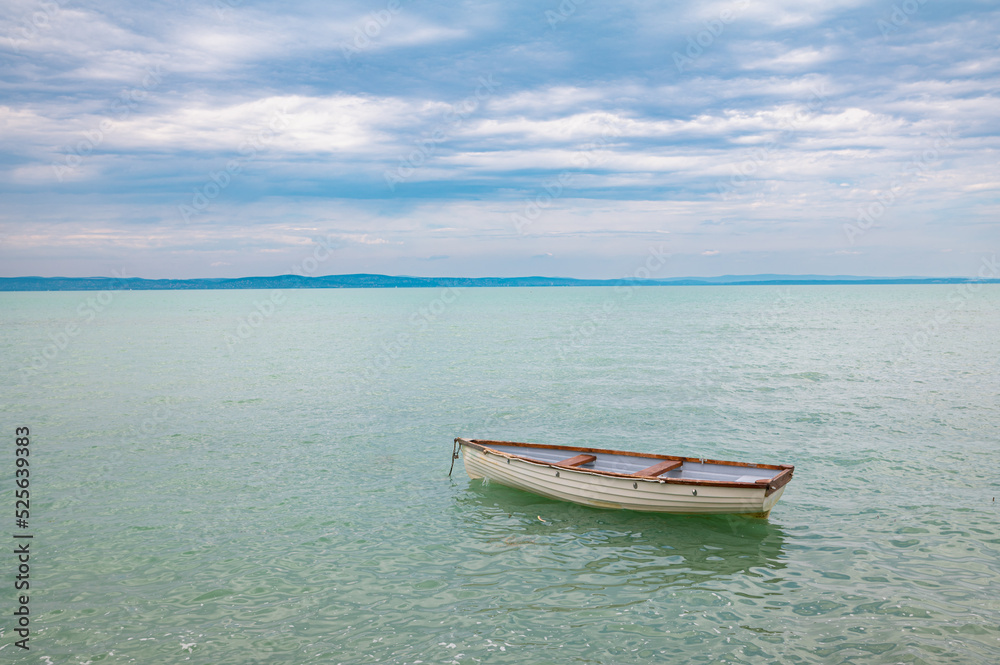 Abandoned sloop on a large lake