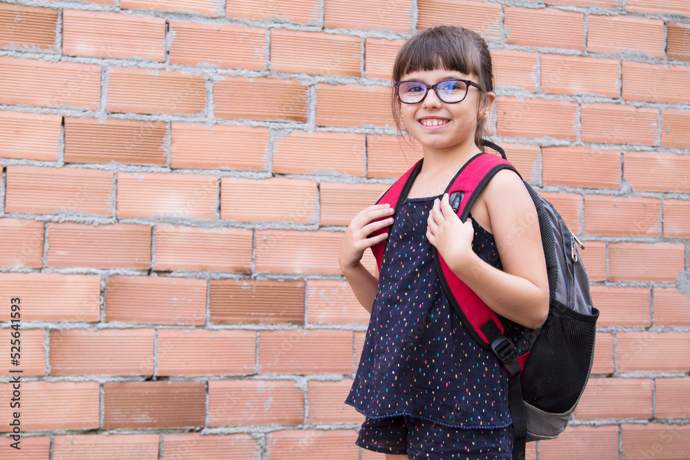 happy girl with backpack on the way to school