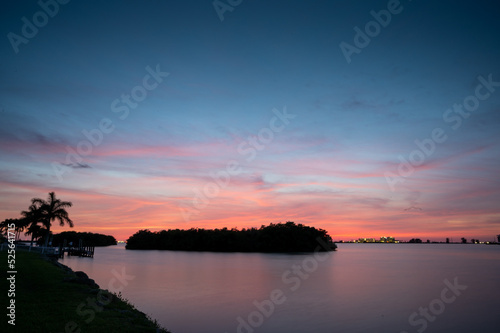 Sunset along river in Florida with silhouette of Mangrove Island
