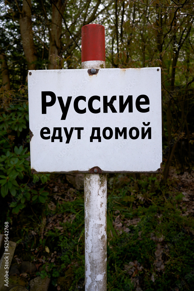 Fototapeta premium Sign in Russian language in a forest with the inscription Russians go home