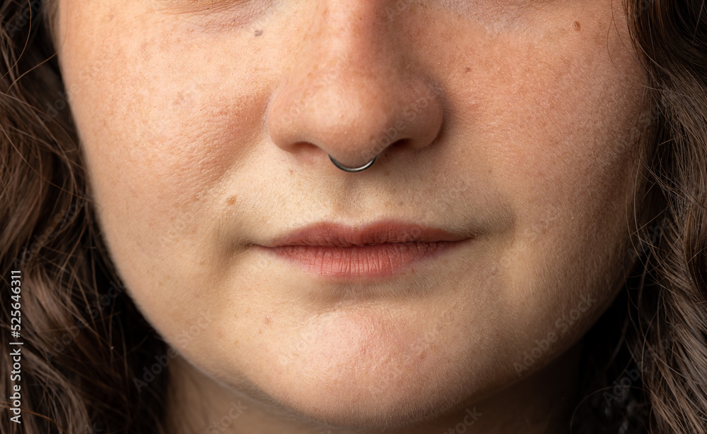 Obraz premium Close up of beautiful young woman with septum nose piercing