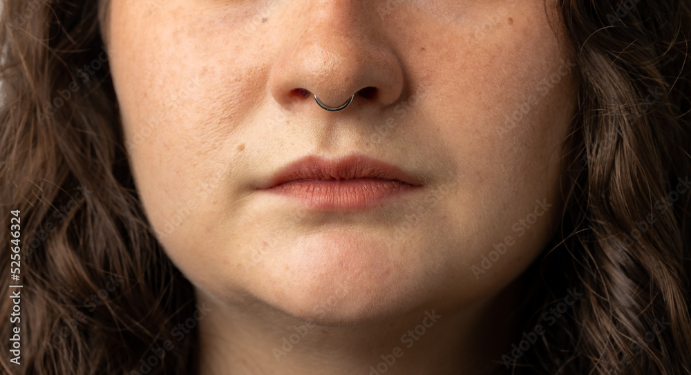 Close up of beautiful young woman with septum nose piercing Close up of beautiful young woman with septum nose piercing