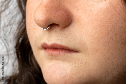 Close up of beautiful young woman with septum nose piercing