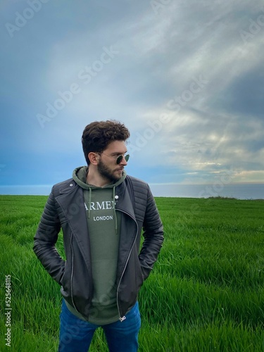 Vertical shot of a male on the background of a field in Istanbul, Akaretler, Turkey photo