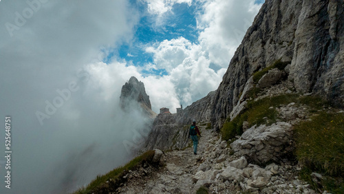 Photography woman hiking and climbing the via ferrata via delle bocchette mountain sign in