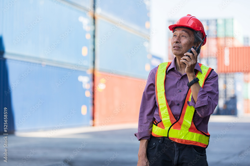 senior factory worker or engineer talking on walkie talkie in containers warehouse storage senior factory worker or engineer talking on walkie talkie in containers warehouse storage