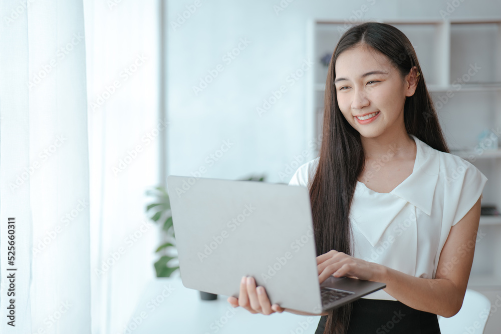 Young beautiful is studying online via laptop and writing on note book at home. Young beautiful is studying online via laptop and writing on note book at home.