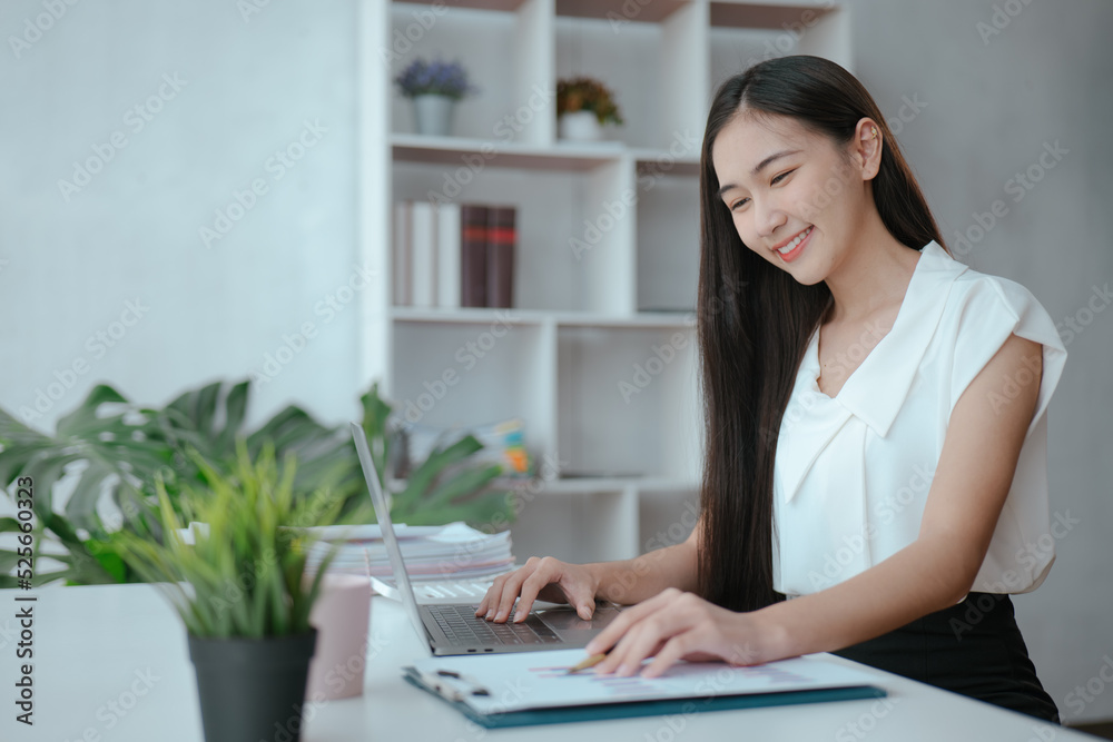 Young beautiful is studying online via laptop and writing on note book at home. Young beautiful is studying online via laptop and writing on note book at home.